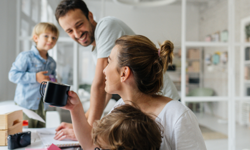 Eltern und Kinder an einem Schreibtisch mit Computertastatur